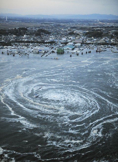 Tsunami swirls near a port in Oarai, Ibaraki Prefecture (state) after Japan was struck by a strong earthquake off its northeastern coast Friday, March 11, 2011.